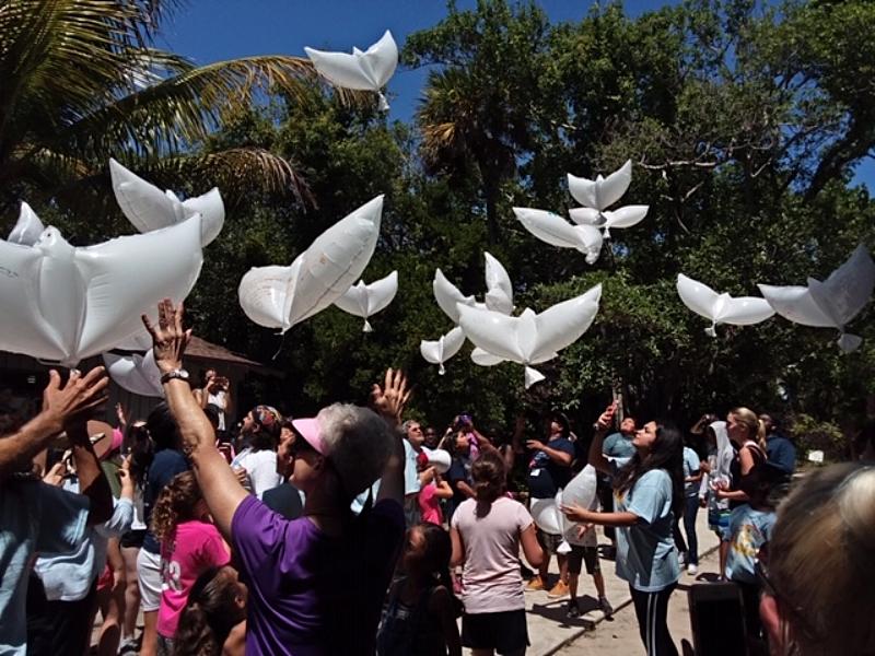 The campers release white dove balloons at the closing ceremony